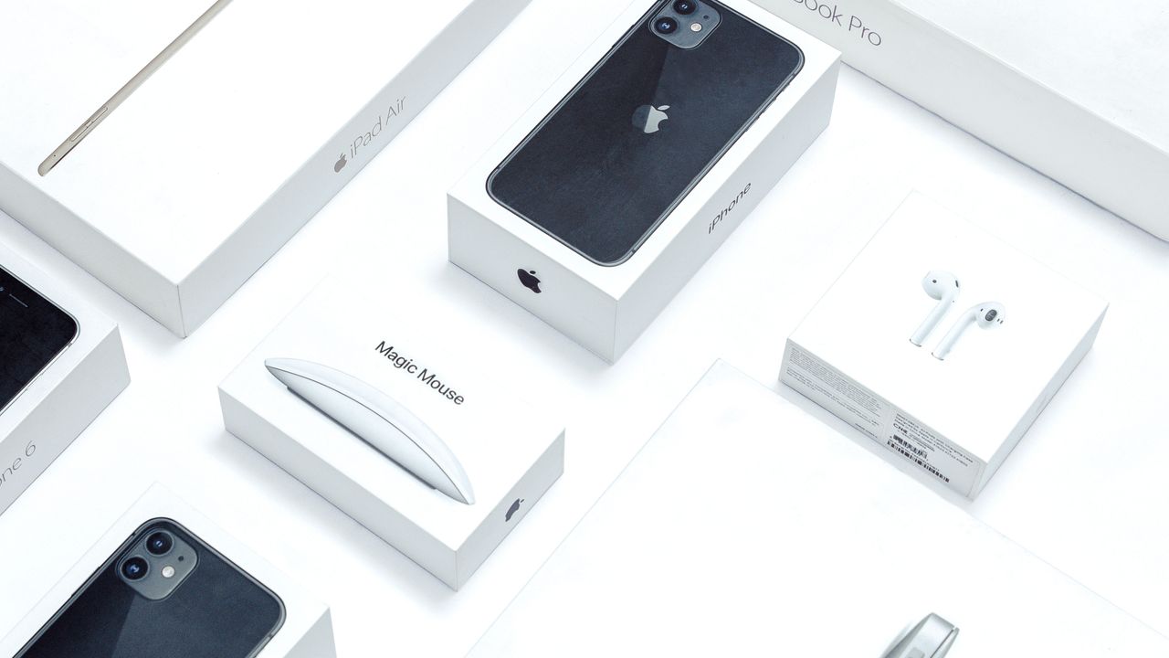 Contact Flat lay of assorted Apple product boxes showcasing technology packaging design.